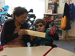 Usha working with a student