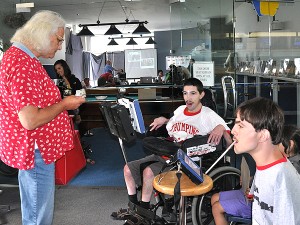 Ben A. and Kolya greet guests and collect the entry donation.
