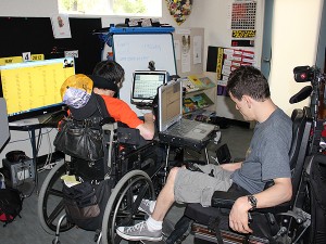 Tyson and Ben brainstorm with Thanh (right hand corner of the television monitor) to come up with their team name.